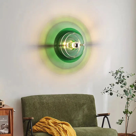 Flying saucer wall light with green acrylic shade in a designer foyer.