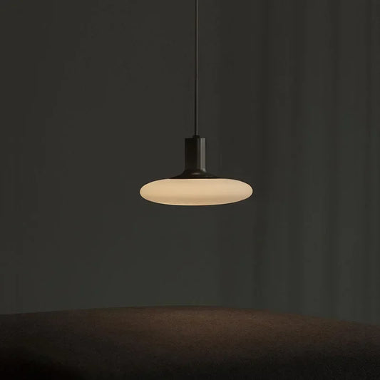 LED pendant lighting featuring a round glass stone shade and iron finish.