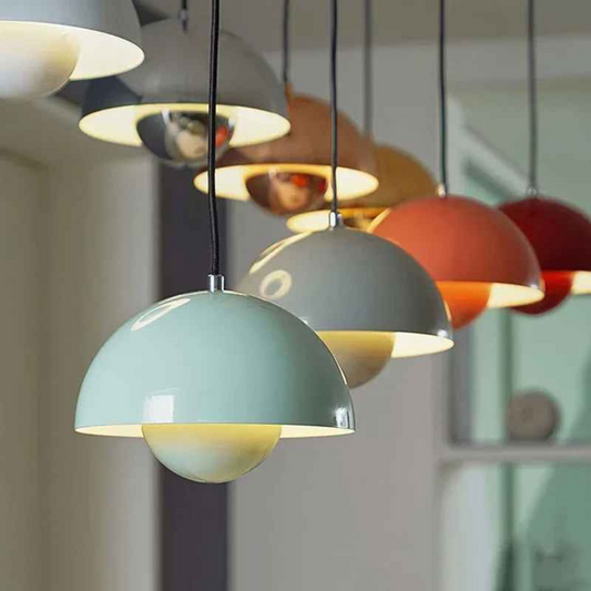 Row of colorful Bauhaus flowerpot pendant lights in sage green, terracotta, red, and gold tones hanging in a modern interior. Ideal for eclectic, Scandinavian, or contemporary spaces.