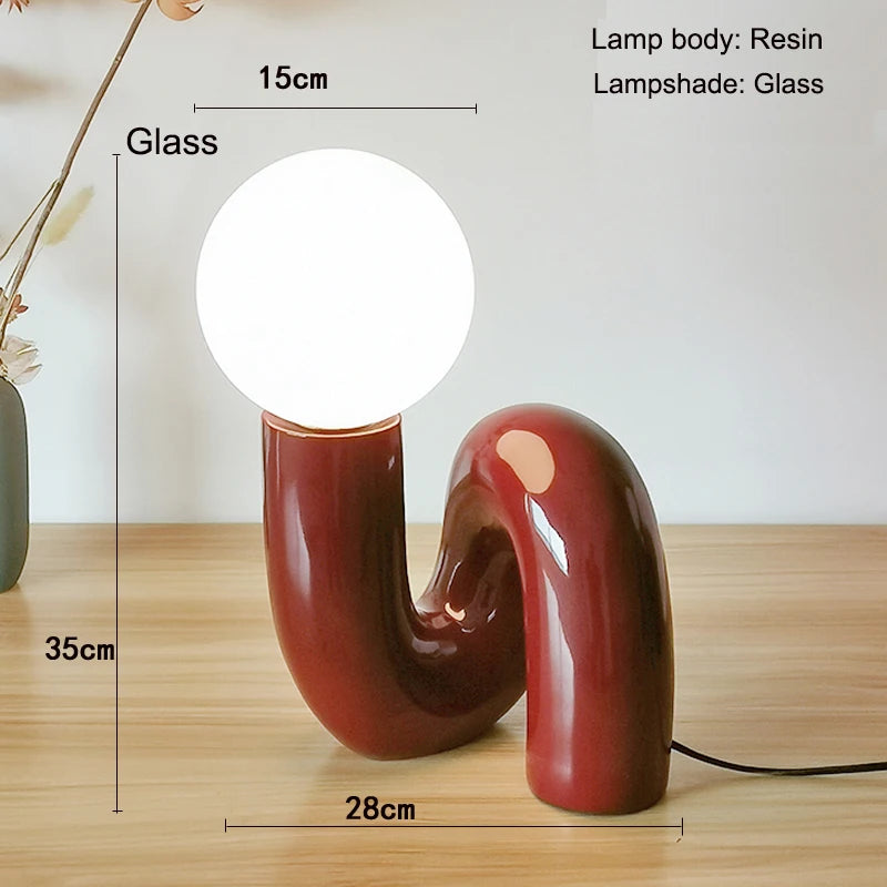 Decorative table lamp with measurements on a wooden surface