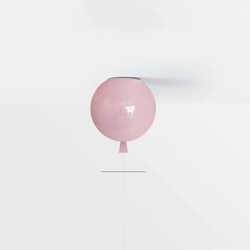 Pink balloon ceiling light with a string on a white background
