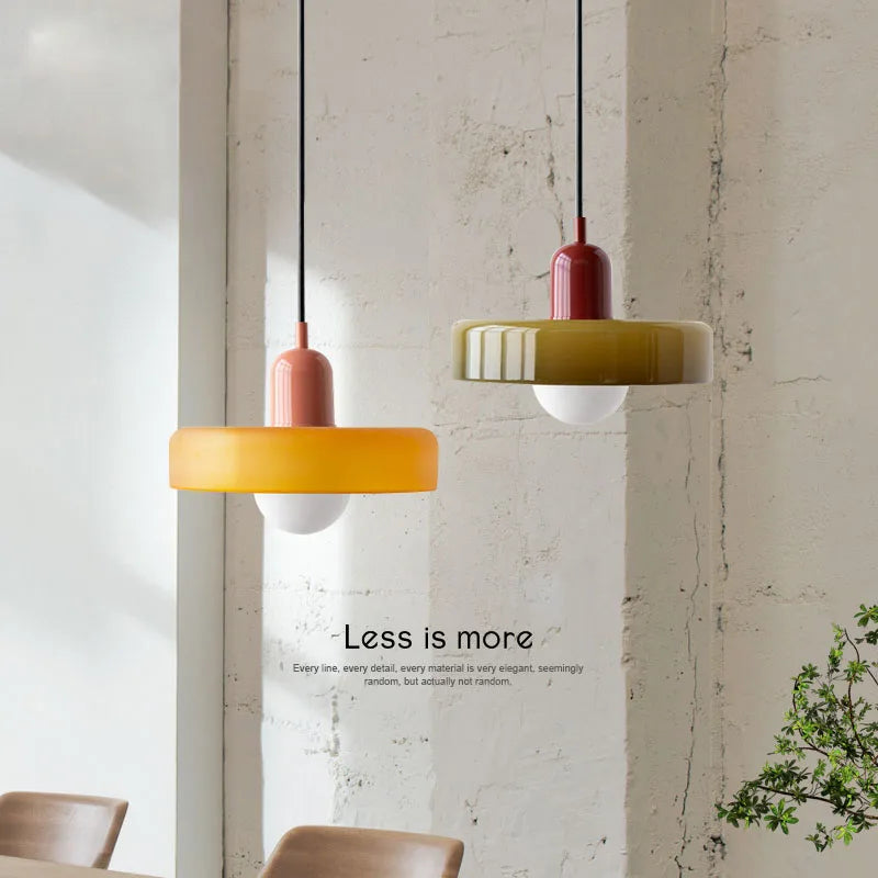 Two pendant lights hanging from the ceiling with a minimalistic interior setting.