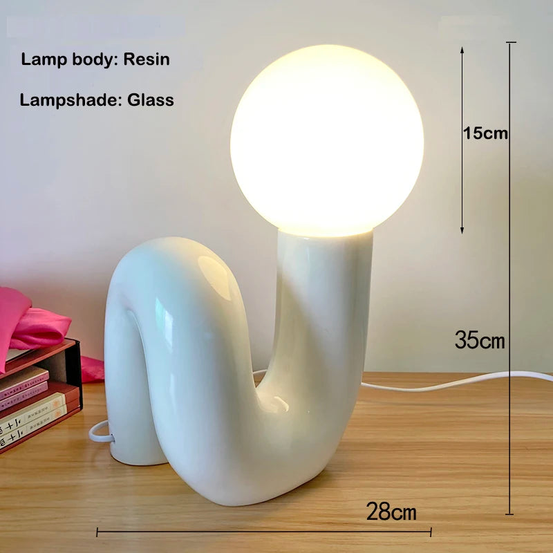 White resin lamp with glass shade on a wooden surface, showing dimensions.