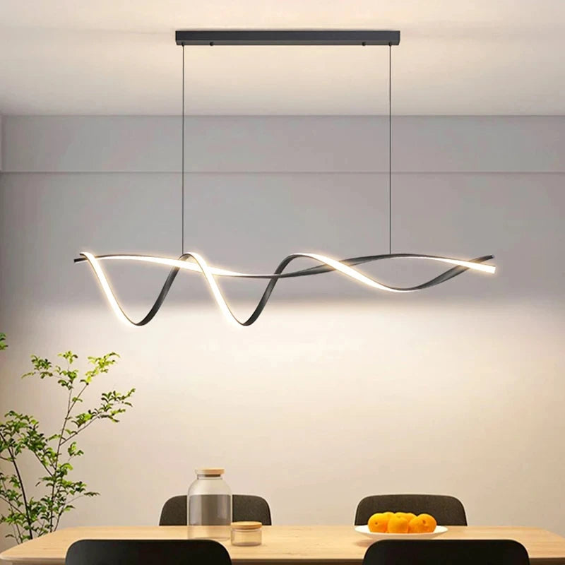Modern pendant light hanging above a dining table with a minimalistic background