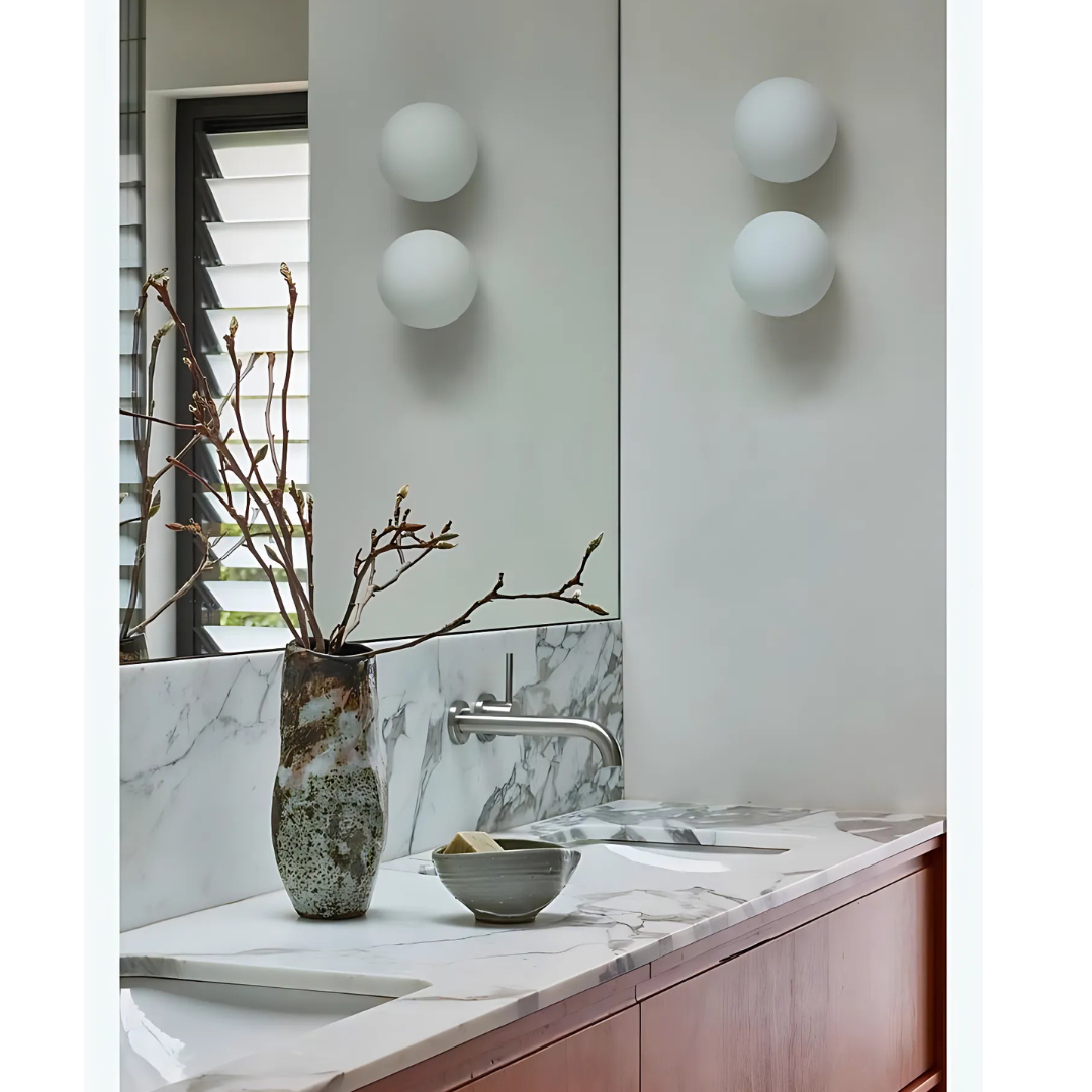 Sleek bathroom design with white globe wall lamp