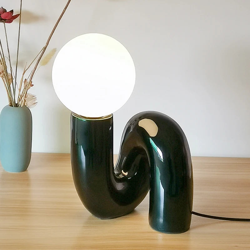 Soft ambient lighting from Soma Nordic table lamp on wooden desk