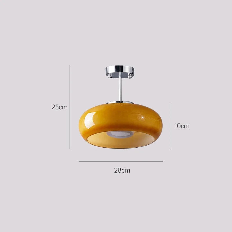 Yellow pendant light with dimensions on a gray background