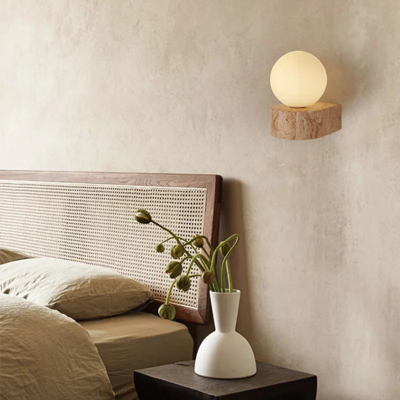 uvik Nordic Travertine LED Wall Sconce mounted as a light luxury bedroom bedside lamp in a modern minimalist room.