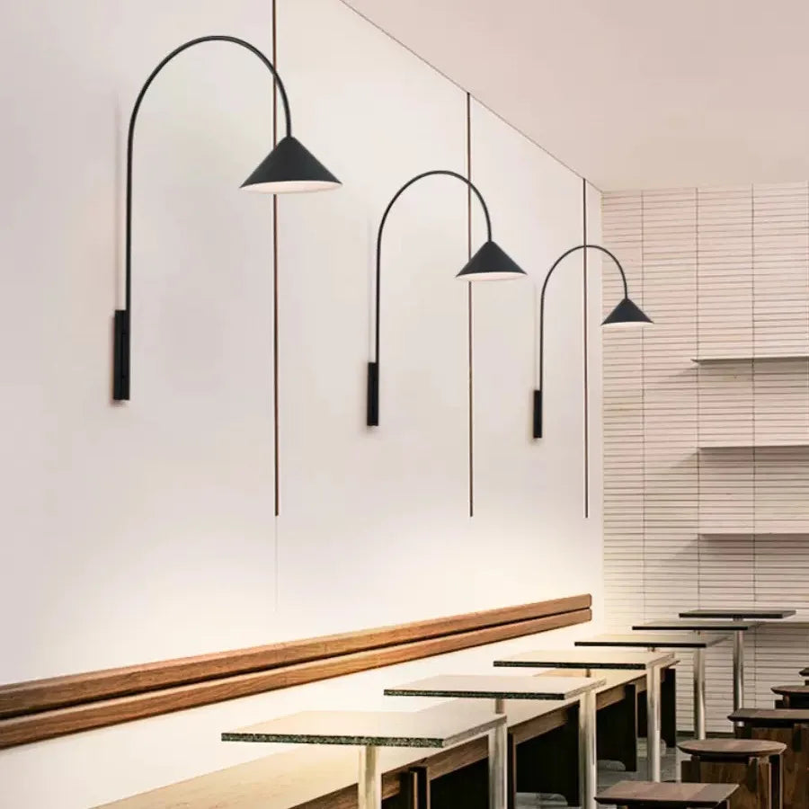 Black wall sconce light fixtures in matte aluminum for architectural background lighting.
