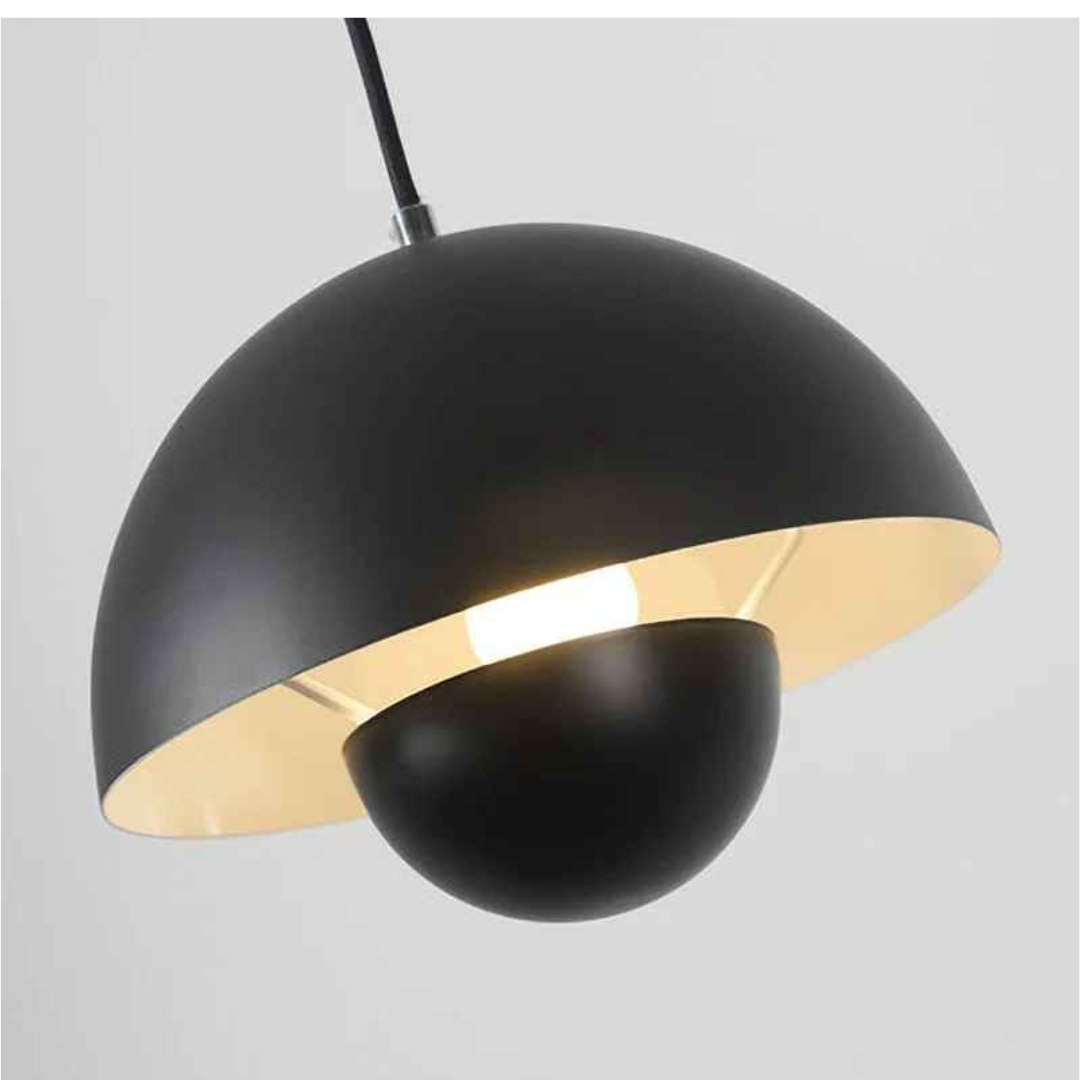 Close-up of matte black flowerpot pendant light with inner gold finish. Bauhaus-inspired dome design perfect for modern dining, kitchen, or office lighting.