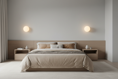 Modern bedroom with a bed, nightstands, and wall lights.