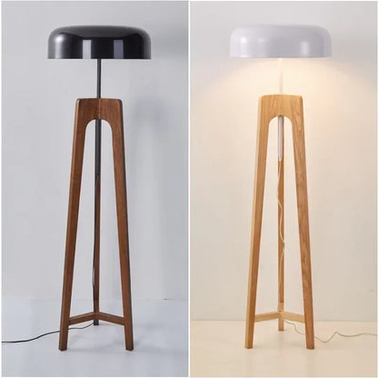 Designer floor light with mushroom-shaped iron shade in a minimalist master bedroom.