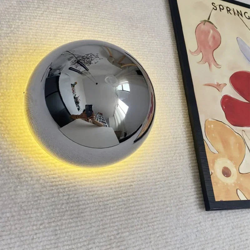 Eclipse bedside wall lamp providing soft up and down glow for luxury master bedrooms.