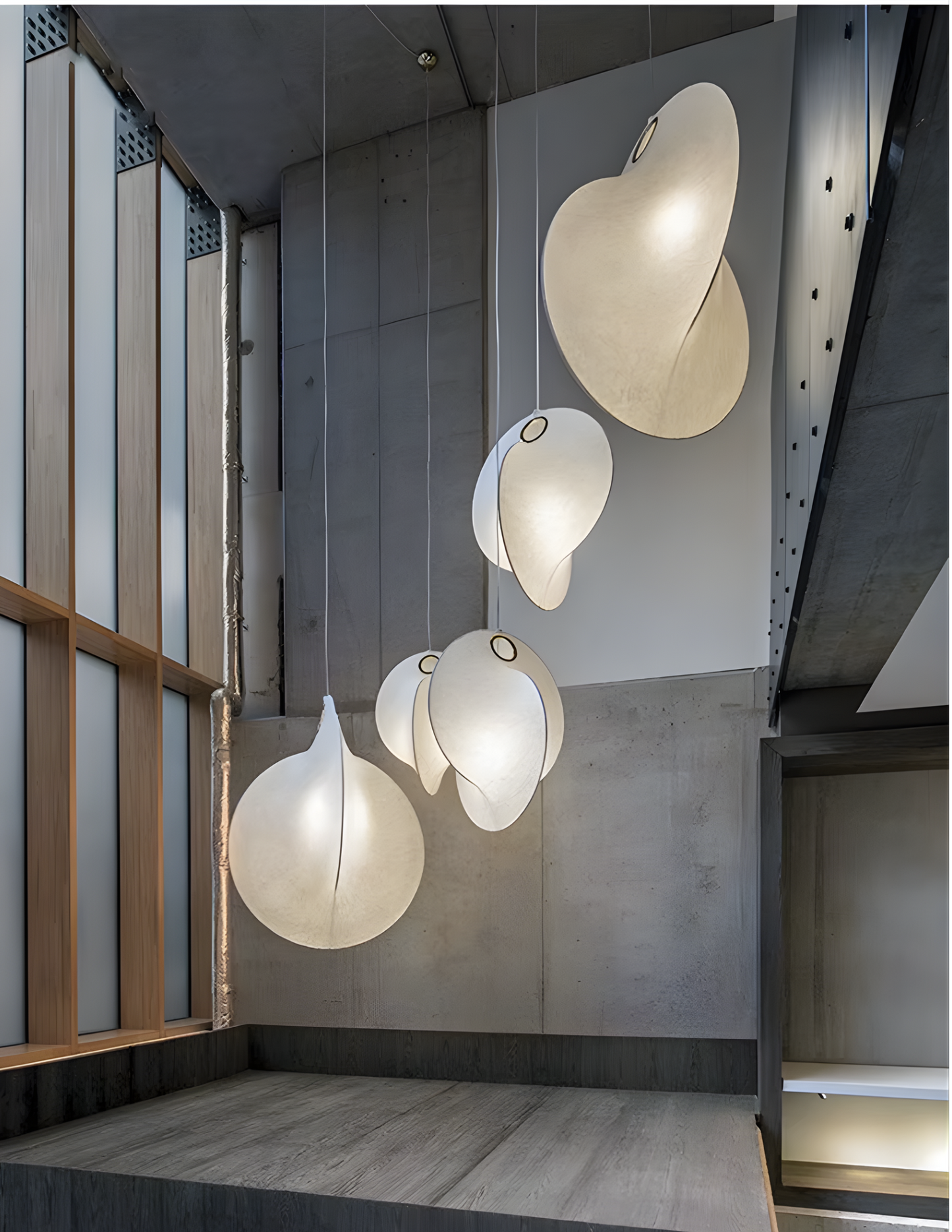 Large pendant lights for high ceilings in a luxury duplex villa staircase.