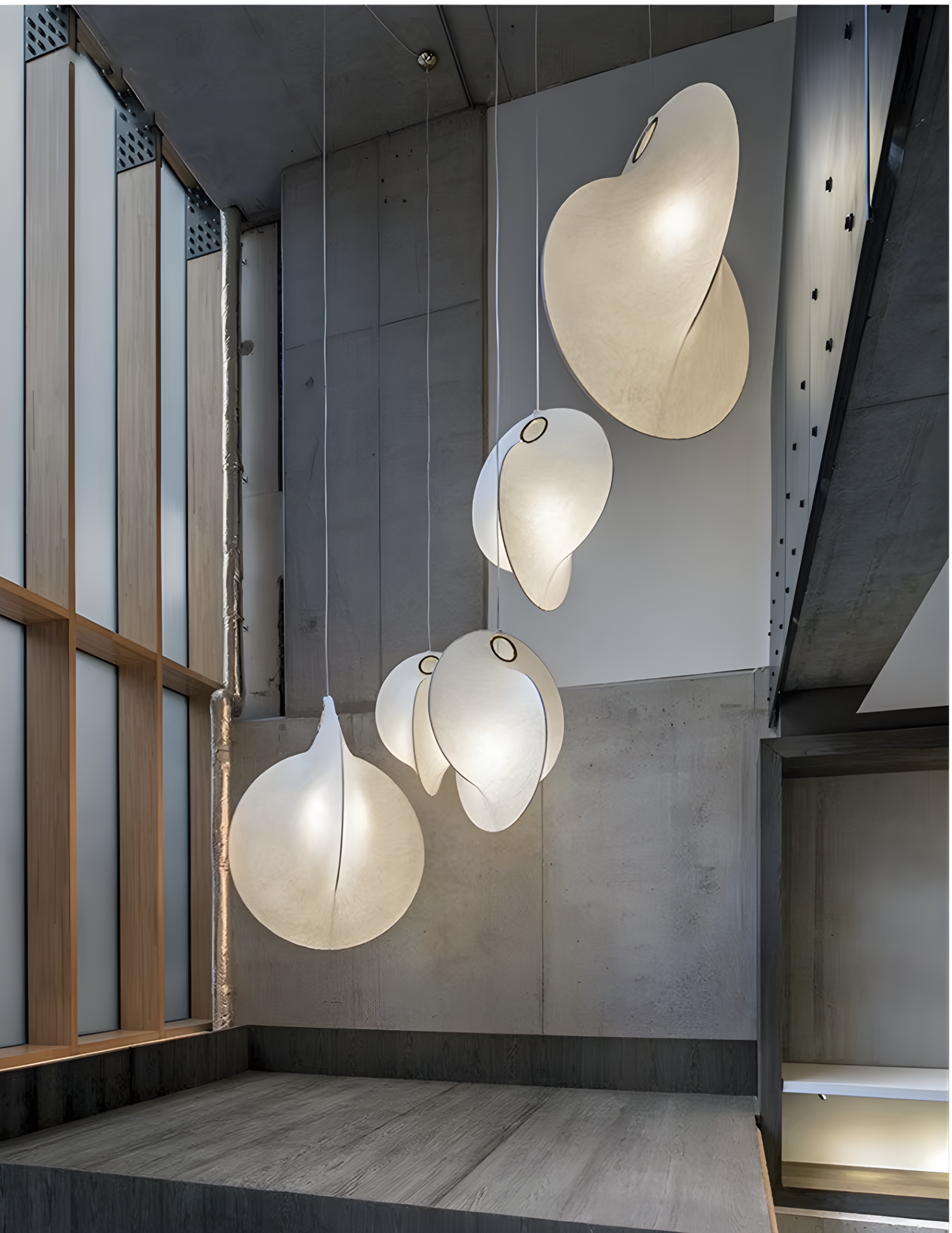 Large pendant lights for high ceilings in a luxury duplex villa staircase.