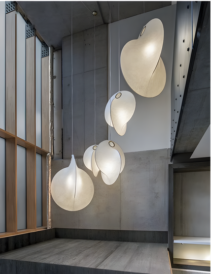 Large pendant lights for high ceilings in a luxury duplex villa staircase.