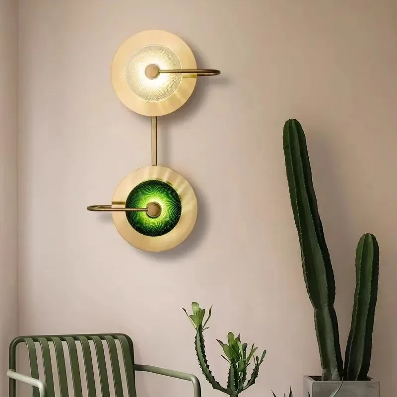 Green crystal wall lamp in emerald green with gold plated finish.