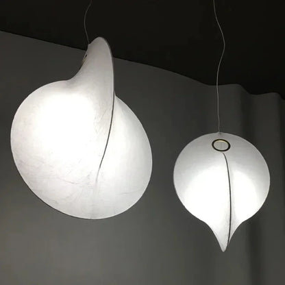 Large pendant lights for high ceilings in a luxury duplex villa staircase.
