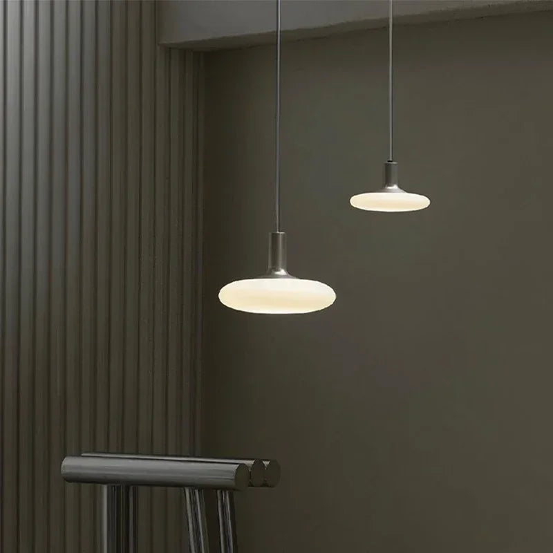 Luxury pendant lighting with milky glass orb for high-end hotel hall decor.