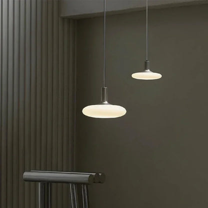 Luxury pendant lighting with milky glass orb for high-end hotel hall decor.