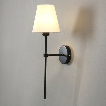 Luxury wall lamp with metal body and fabric shade for modern apartment interiors.