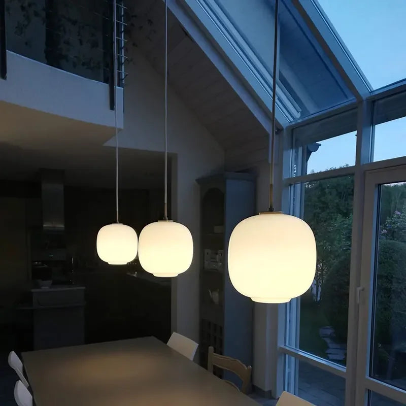 Minimalist pendant lighting for bedside reading in a master bedroom suite.