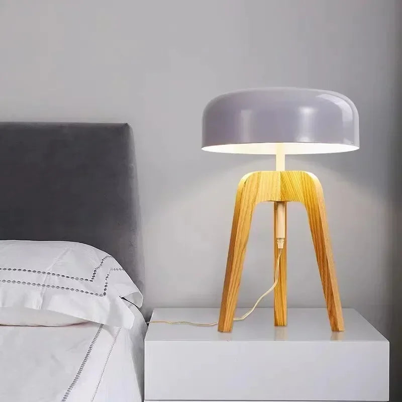 Minimalist table lamps with sculptural through-carved wood details in a Nordic home.