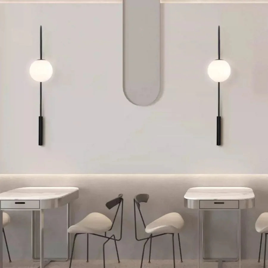 Minimalist wall sconces featuring a long vertical pole and matte black finish.