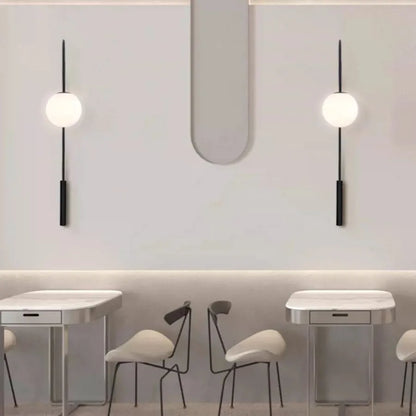 Minimalist wall sconces featuring a long vertical pole and matte black finish.