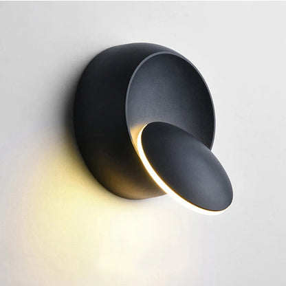 Modern Adjustable LED Wall Light in matte black for a minimalist bedroom.