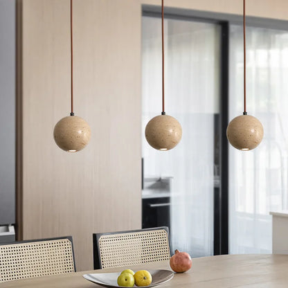 Modern kitchen island lighting with natural stone ball pendants.