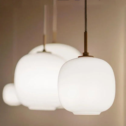 Modern pendant lights with white glass ball shade for Nordic dining room decor.