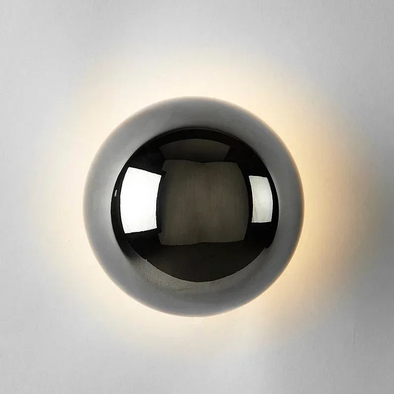Modern silver plated wall light with turbine silhouette and high-shine chrome finish.