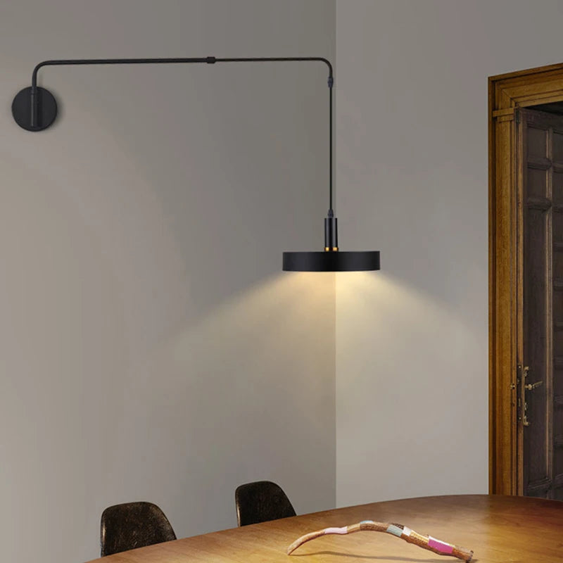 Modern wall sconces with long black adjustable arm for bedroom bedside reading.