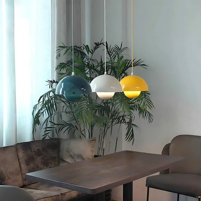 Nordic Bauhaus pendant lights in yellow, white, and blue hanging above modern dining space