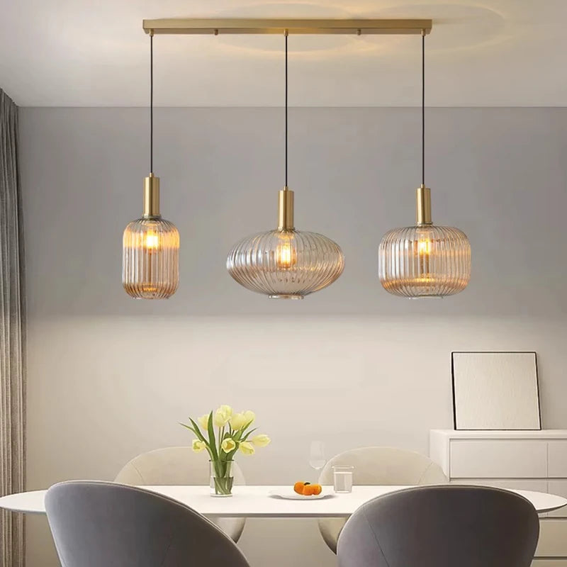 Modern dining room with three pendant lights hanging above a table.
