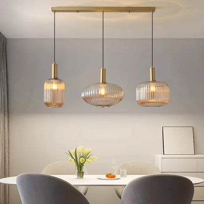Modern dining room with three pendant lights hanging above a table.