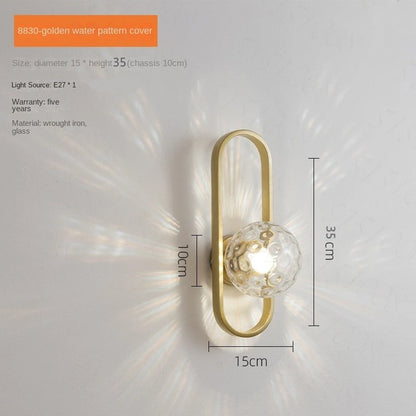 Wall-mounted gold light fixture with dimensions on a white background