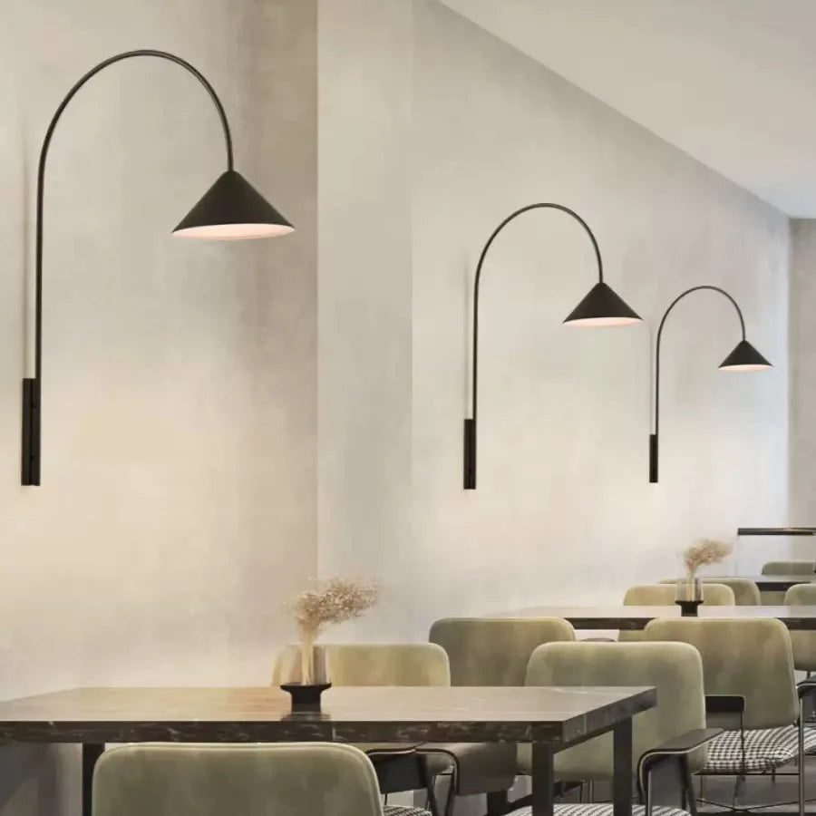 Modern wall sconces with long black pole design for minimalist dining room decor.