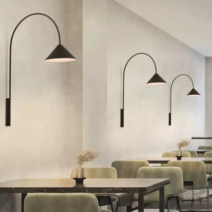 Modern wall sconces with long black pole design for minimalist dining room decor.