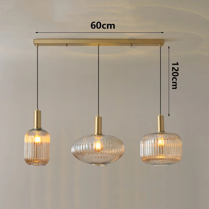 Three pendant lights with measurements on a plain background