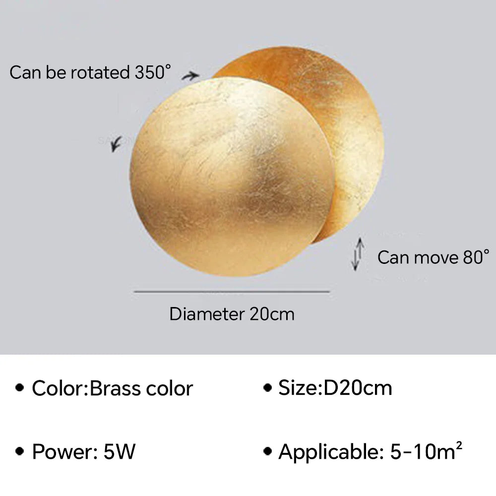 Brass-colored spherical light fixture with rotation and movement capabilities on a gray background.