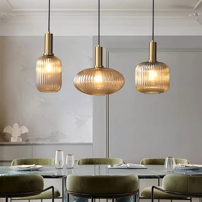 Modern dining room with three pendant lights hanging above a table.