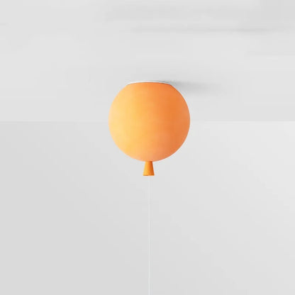 Orange balloon-shaped lamp on a white background