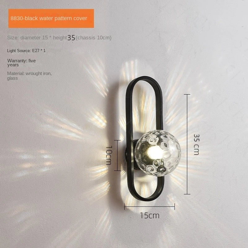 Wall-mounted light fixture with black metal frame and glass cover, dimensions displayed.