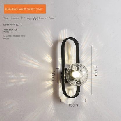 Wall-mounted light fixture with black metal frame and glass cover, dimensions displayed.
