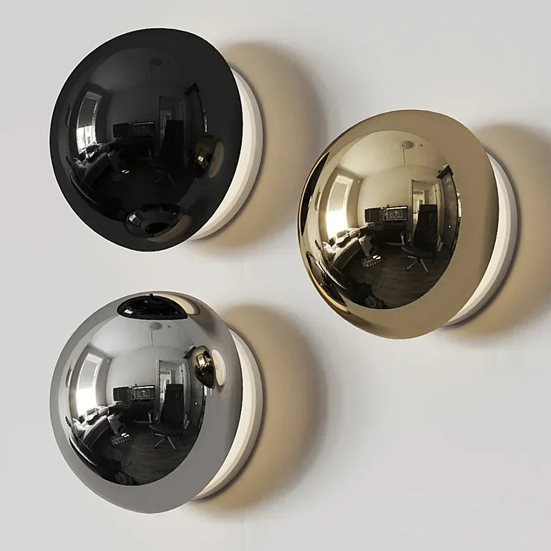 Silver Bauhaus wall lamp with circular metallic design for modernist living room interiors.