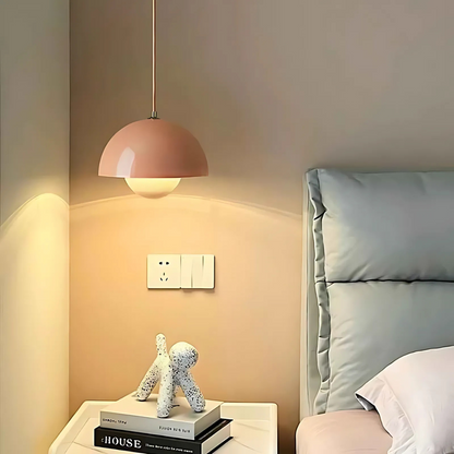 Soft pink Bauhaus flowerpot pendant light glowing above a modern nightstand in a cozy minimalist bedroom. Ideal for Japandi, Nordic, and feminine interiors.