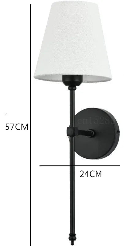 Wall mounted lamp with a classic American style fabric shade in a modern corridor.